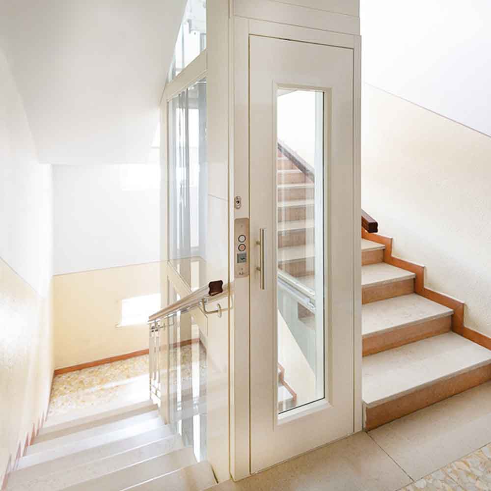 compact home elevator installed beside stairs