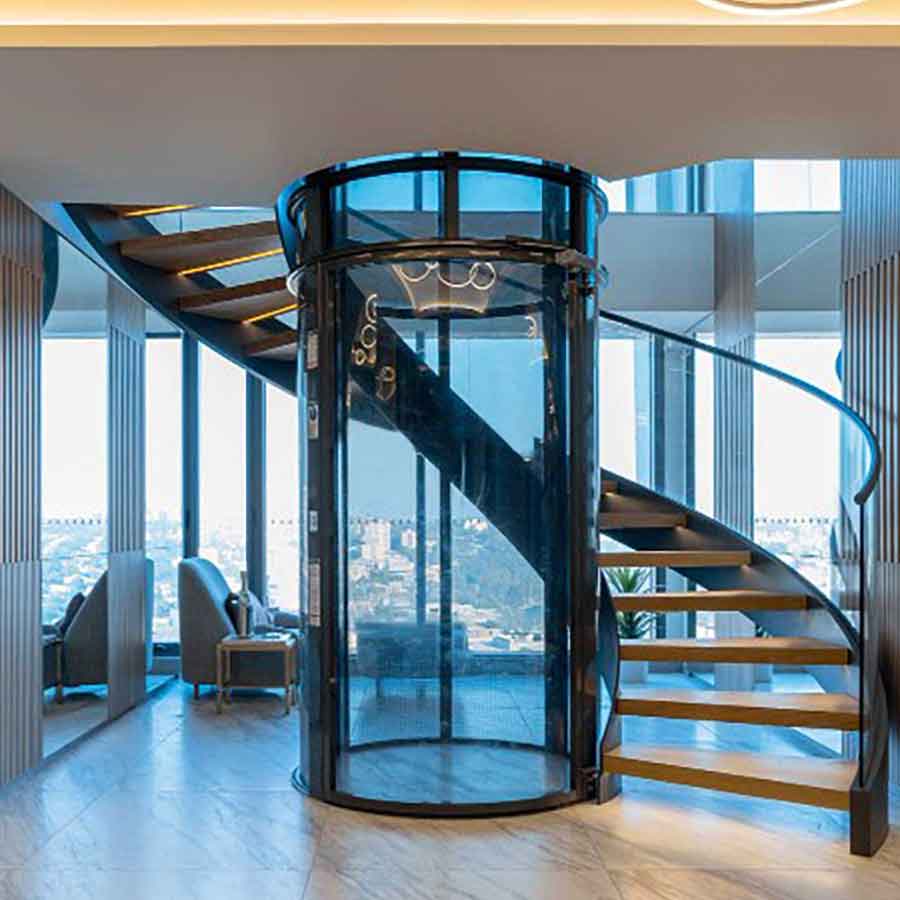 round glass elevator installed beside spiral staircase